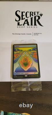 Secret Lair X Strange Sands Rainbow Foil Island (Sacred Veginee Land). Sealed