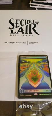 Secret Lair X Strange Sands Rainbow Foil Island (Sacred Veginee Land). Sealed